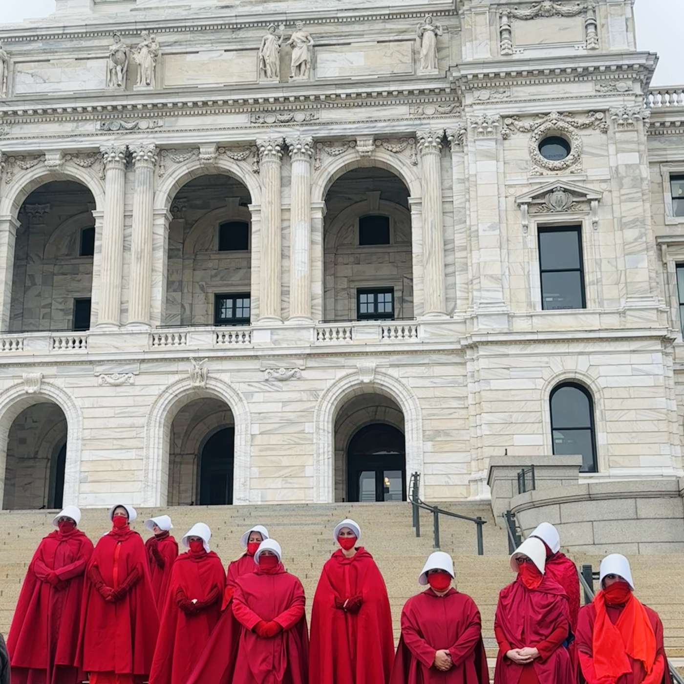 Protesters in Red Cloaks and White Bonnets Call Attention to Civil Rights episode artwork